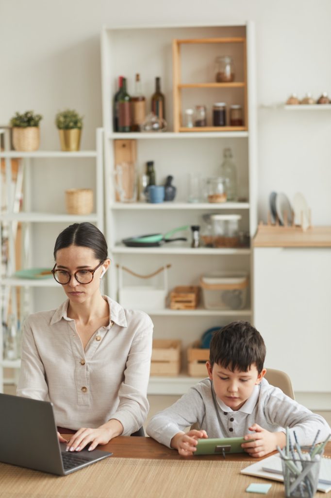 Businesswoman Working at Home Office with Son
